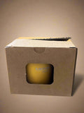 Yellow soap bar in a cardboard box with 'Gavilanes' branding, on a reflective surface.